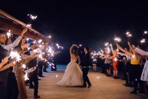 The groom dances with the bride as they do a sparkler exit at Quarry Farm, Australia.