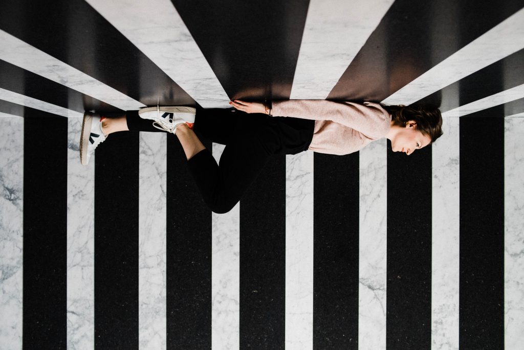 An image of a woman lying on a marble installation at Milan Design Week 2019.