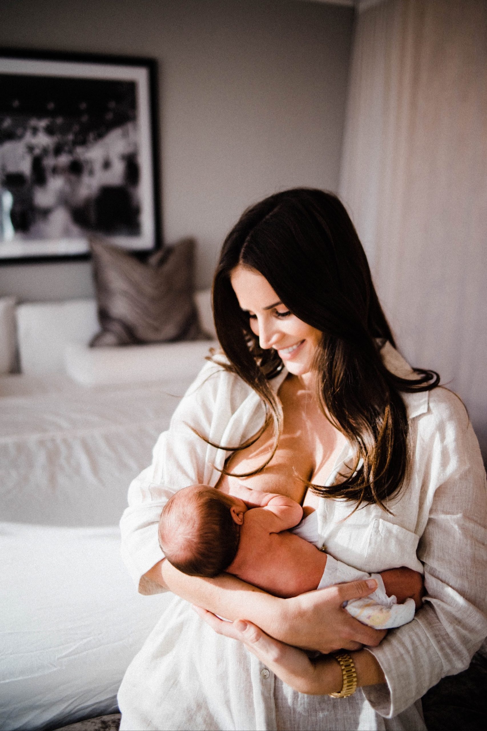 A natural newborn portrait of a Mum breastfeeding her new baby girl.