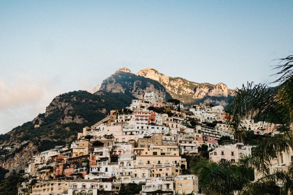 A landscape image of Positano's famous colourful town, with colourful palazzi built up the mountain, to demonstrate How to Elope in Positano.